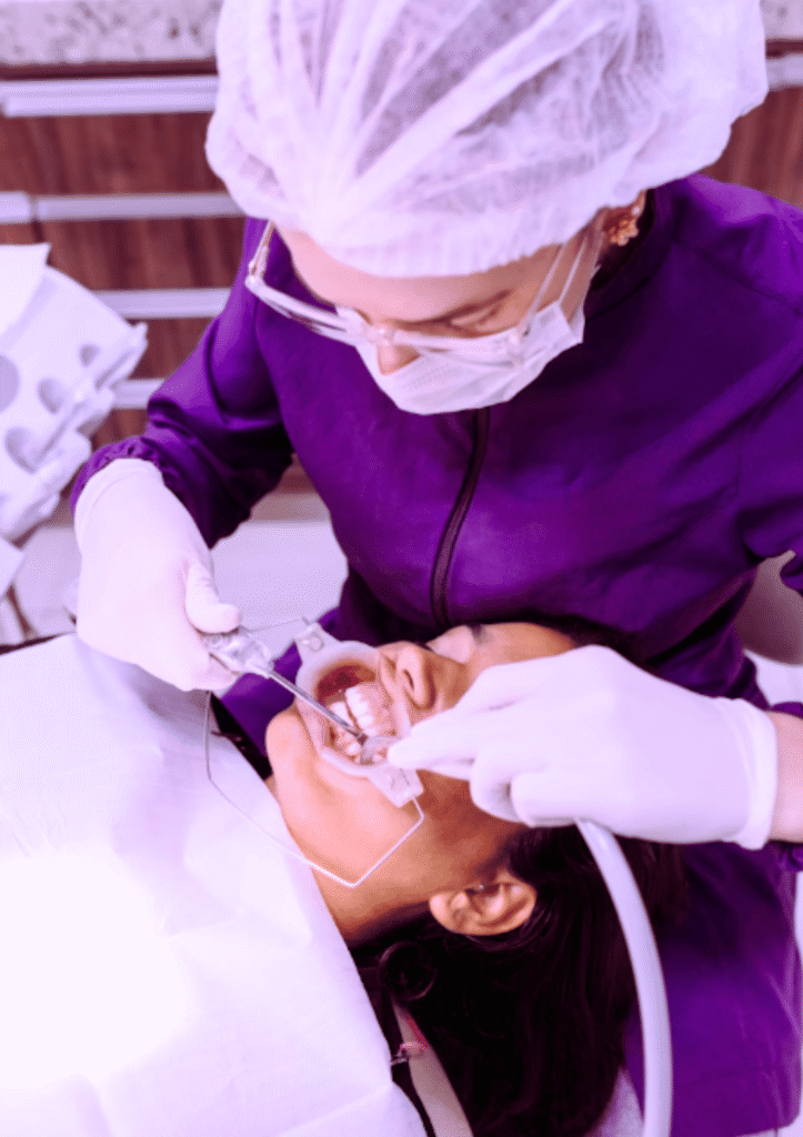 Cosmetic dentist performing dental treatment on a patient at a cosmetic dentistry clinic in Beckenham